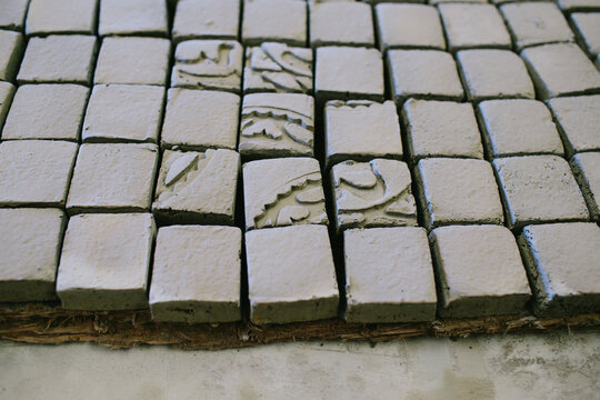 Tiny tiles with arabic mosaics before paint