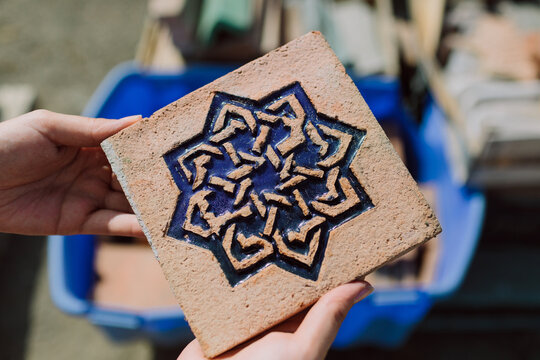 Man showing a finished glazed tile