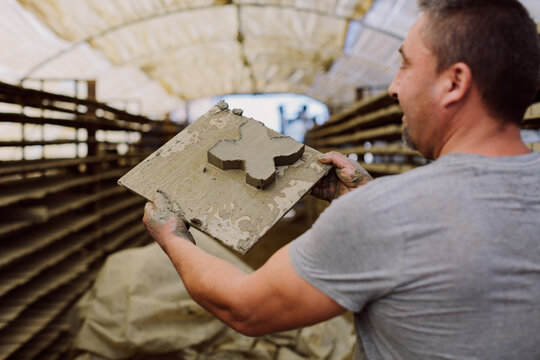 Happy worker showing his workpiece