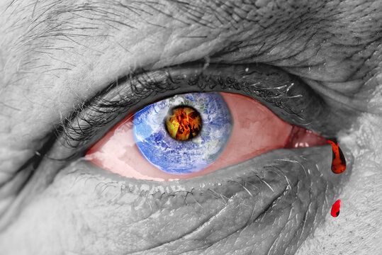 The earth globe inside of a man's eye. the concept of the destruction of the earth in the human eye. death of the planet due to an atomic explosion or nuclear strike