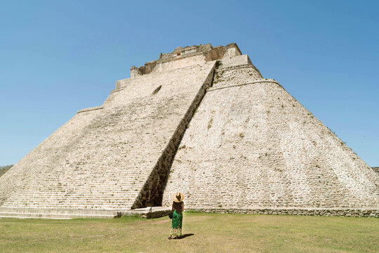 A tourist woman appreciating a big Mayan pyramid