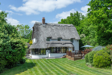 Traditional thatch cottage in England. Set in the garden.