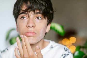 Teenager taking care his face from home