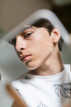 Teenager reflected in mirror