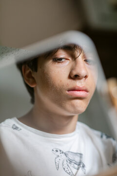 Serious teenager reflected in mirror