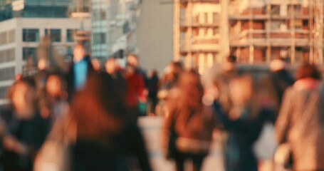 A crowd of people walking together on the street