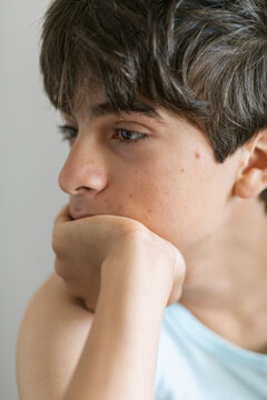 Pensive teen boy studio portrait