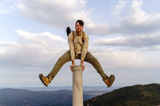 Fun portrait of man on top of mountain peak