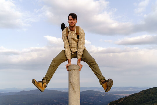 Fun portrait of man on top of mountain peak