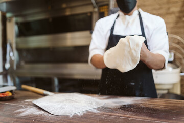 Anonymous chef making a pizza dough
