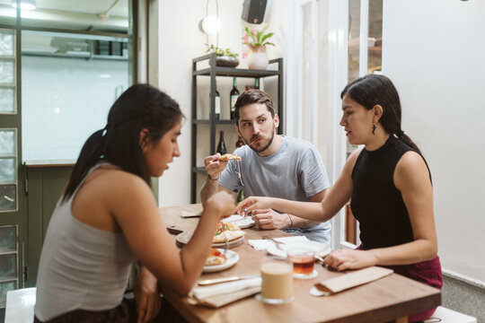 Diverse friends sharing a meal in a restaurant