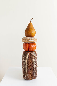 Pear, bagel and tomato stacked on bread