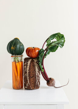 Still life of bread, squash, pickled carrot and vegetables