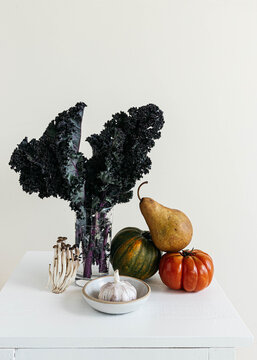 Still life of vegetables and fruit on white table
