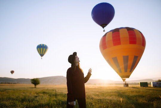 Young woman enjoying hot air balloons show