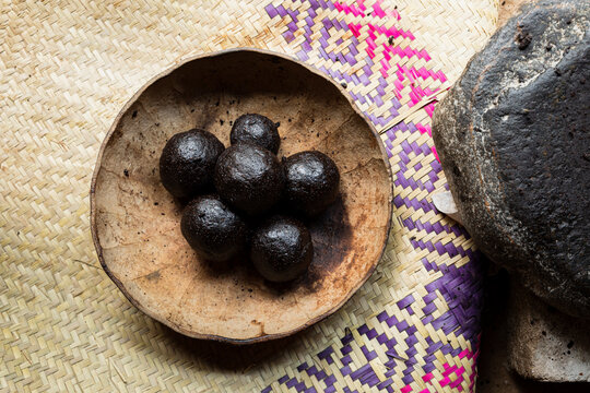 Cacao balls inside a pumpkin container on a colored petate
