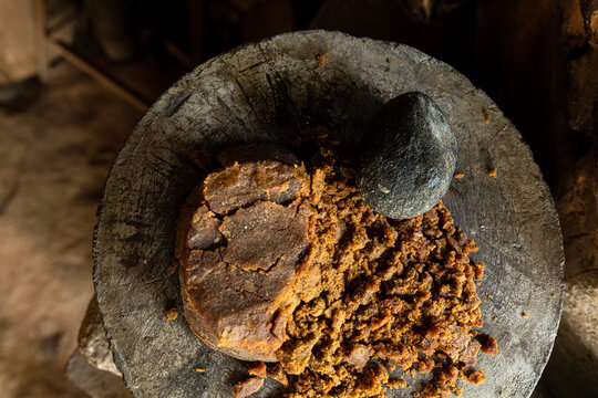 piloncillo or sugar cane ground with a stone in a traditional kitchen
