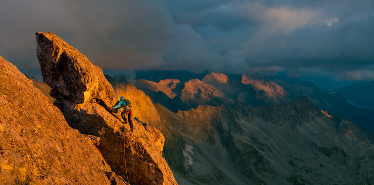 Woman climbing in breathtaking mountain landscape 