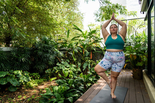 Plus size Gen Z woman doing yoga