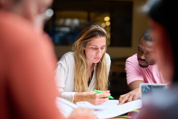 Diverse colleagues analyzing data together