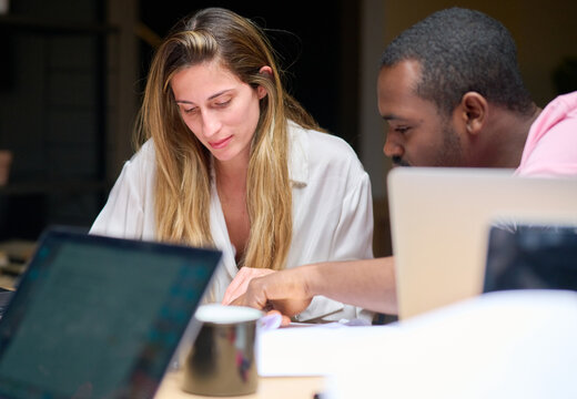 Multiracial colleagues analyzing documents