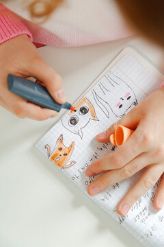 Anonymous girl doodling in notepad
