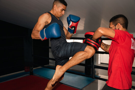Man training boxing with his coach