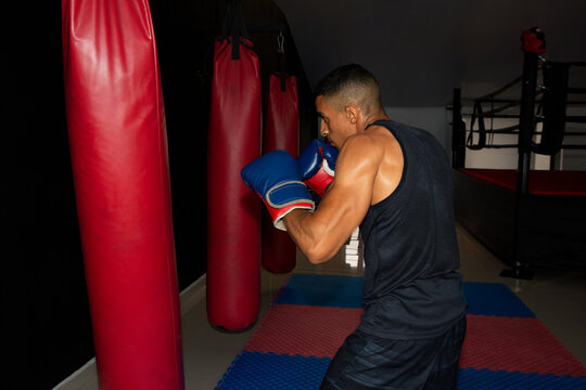 Horizontal photo of a boxer training on the punching bag