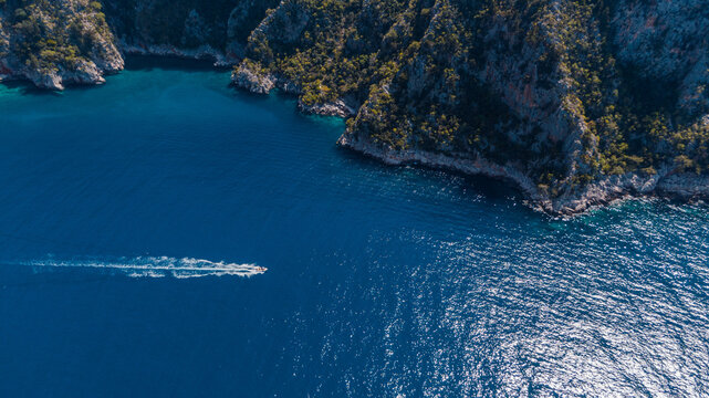 motorboat speeding in azure water along the promontory 