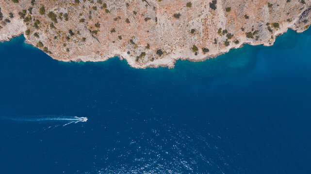 aerial top-dow view of a speed boat in blue water, copy-space pattern