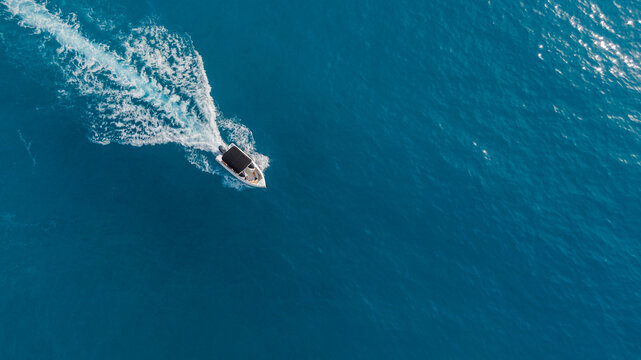boat with tourists speeding in azure water