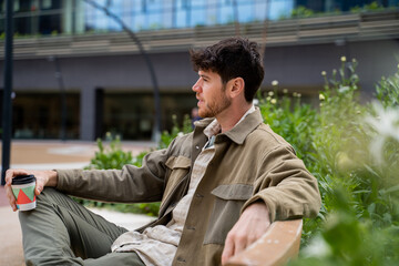 Man sitting at park with coffee take away
