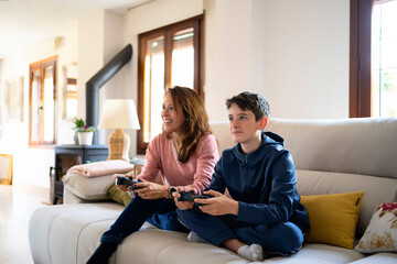 Content woman playing videogame with son