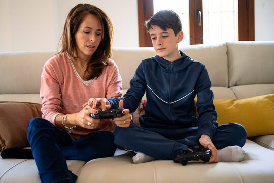 Son with mother preparing for playing videogame