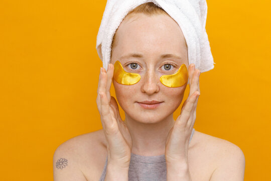 Woman Using Under-Eye Patches on yellow background