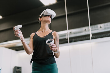 Woman wearing VR goggles touching air 