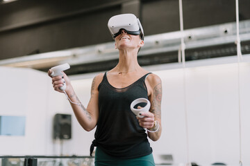 Woman wearing VR goggles touching air 