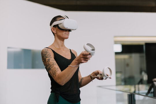 Woman wearing VR goggles touching air 