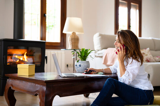Cheerful businesswoman reading data to customer