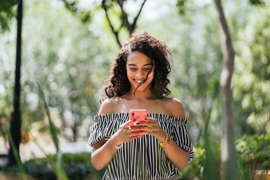 Latin Woman Texting On Her Phone