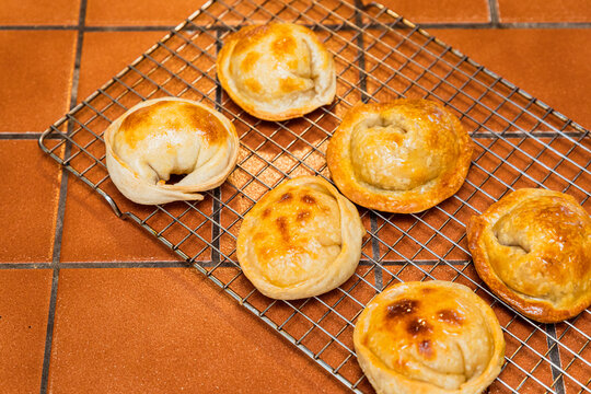 Angle view of a rack of Argentinian empanadas in a kitchen counter