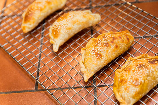Angle view of a rack of Argentinian empanadas in a kitchen counter