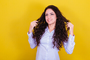 Enterprising woman, businesswoman, messing with her hair.