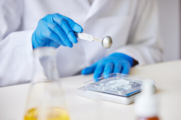 Faceless specialist weighing chemical ingredient