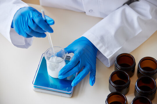 Unrecognizable pharmacist making cosmetic product