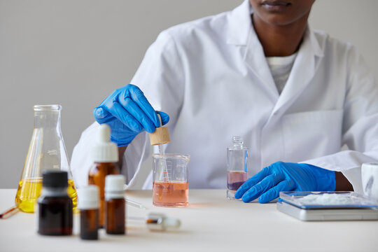 Unrecognizable pharmacist making cosmetic product