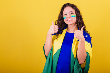 Woman soccer fan, fan of brazil, world cup, looking at camera with hand on chin. interactive photo.