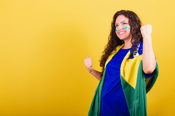 Fototapeta Soccer fan woman, brazil fan, world cup, closed fists, celebrating, cheering for a goal. obraz