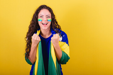 Soccer fan woman, brazil fan, world cup, holding flag and cheering