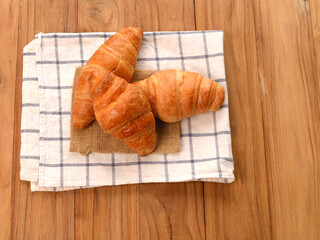 croissant on a napkin put on the wooden table